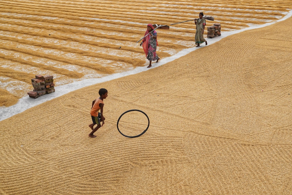 a couple of people that are standing in the sand