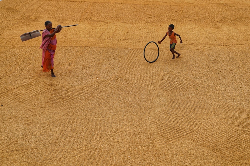 a couple of people that are standing in the sand