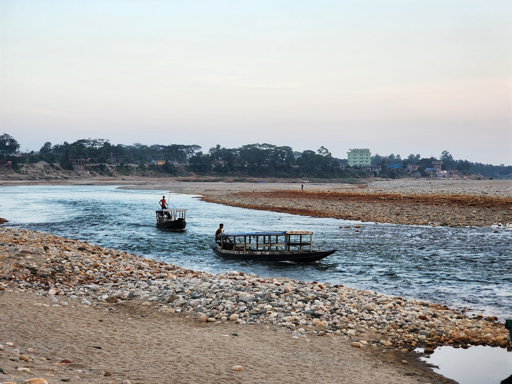 a couple of boats floating on top of a river