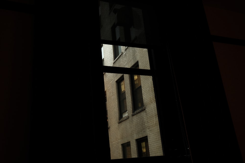 a view of a building through a window at night