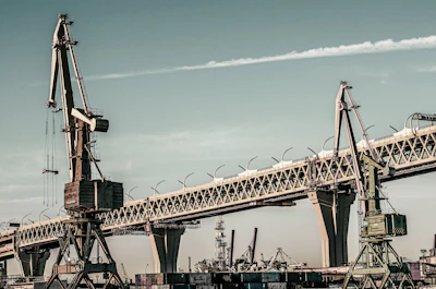 Modern industrial park with cranes and heavy machinery actively working on infrastructure development.