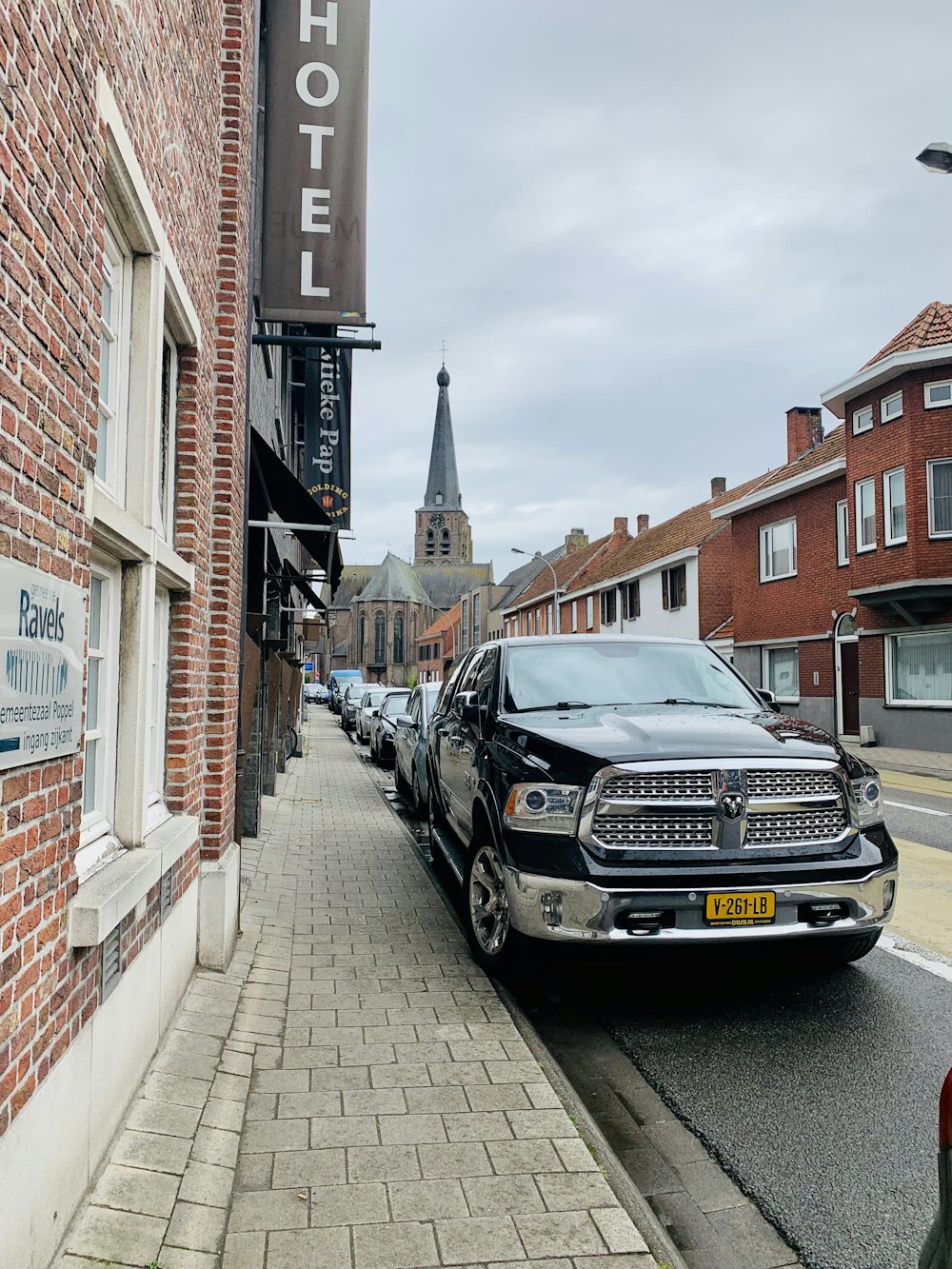 a truck parked on the side of a road next to a building