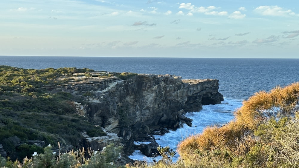 a rocky cliff overlooks a body of water