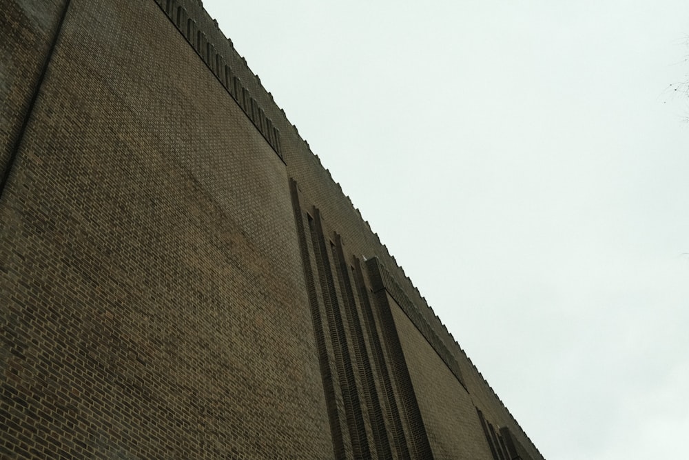 a clock on the side of a brick building