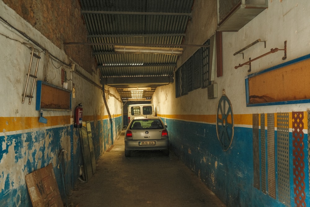 a car is parked in a narrow tunnel