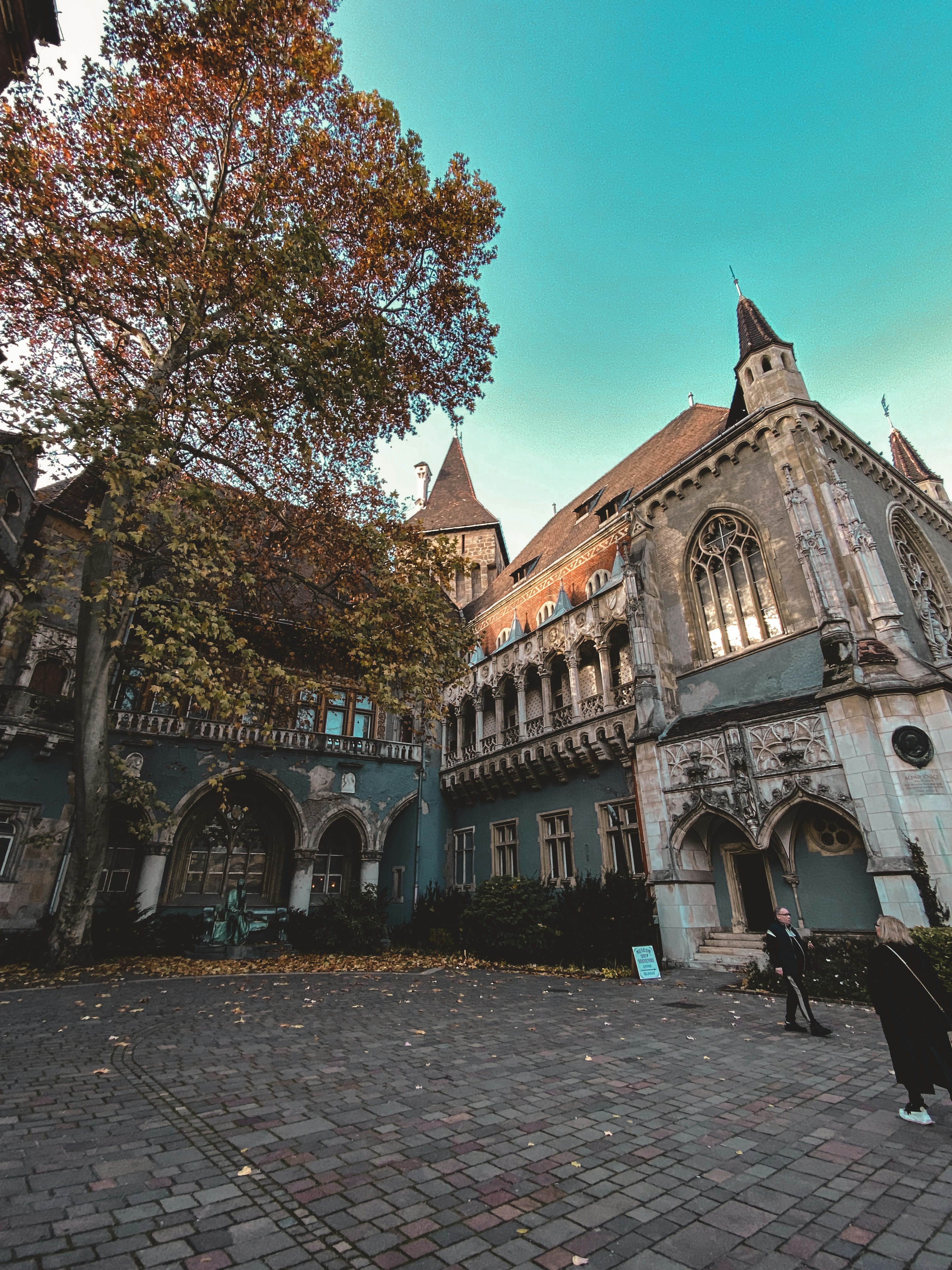 A large building with a clock tower on top of it photo – Free Statue ...