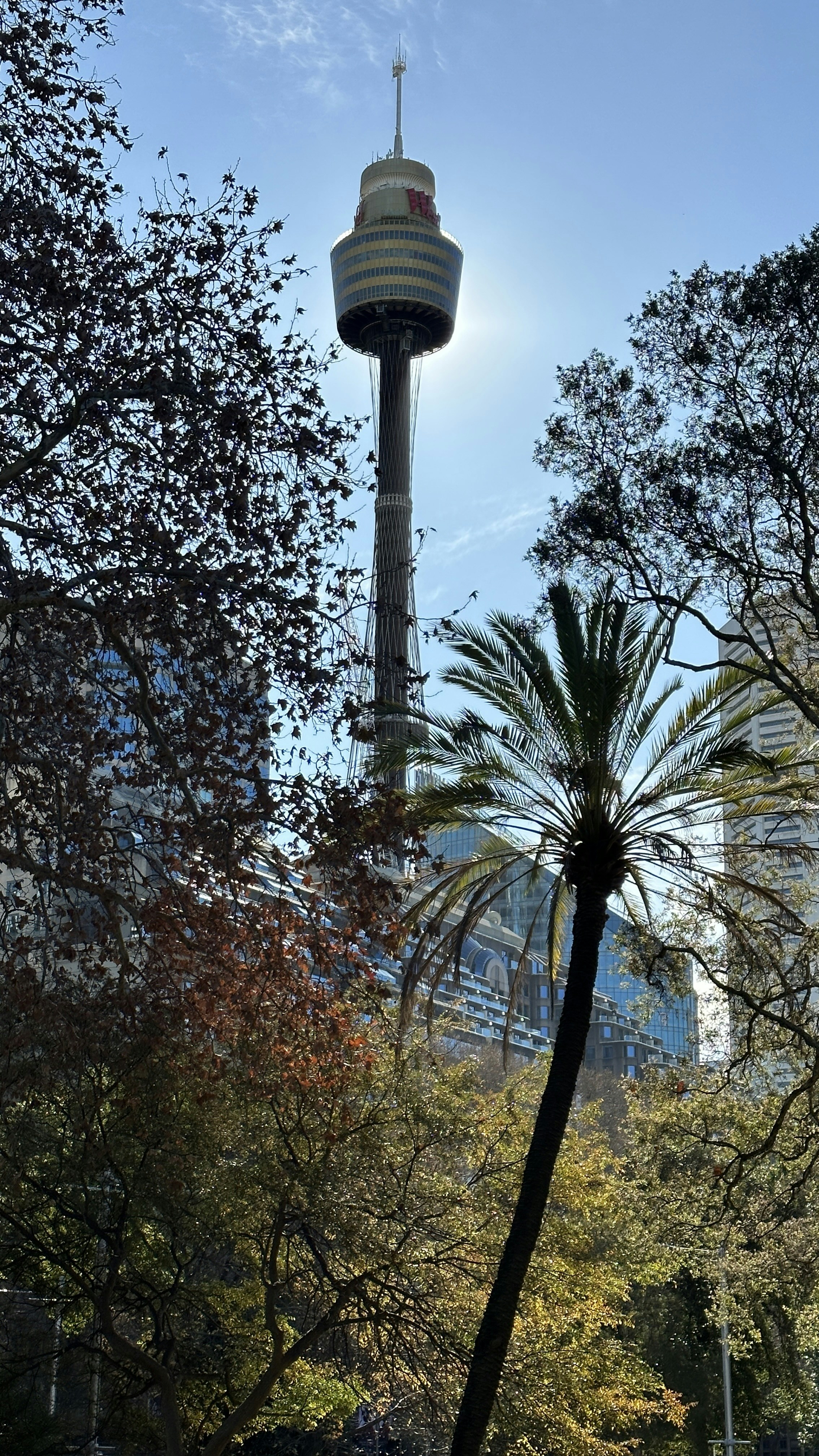 a tall tower with a sky scraper in the background