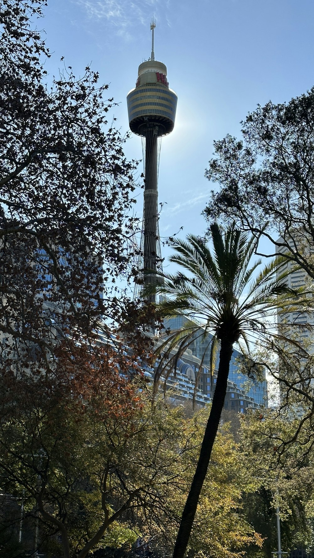 a tall tower with a sky scraper in the background