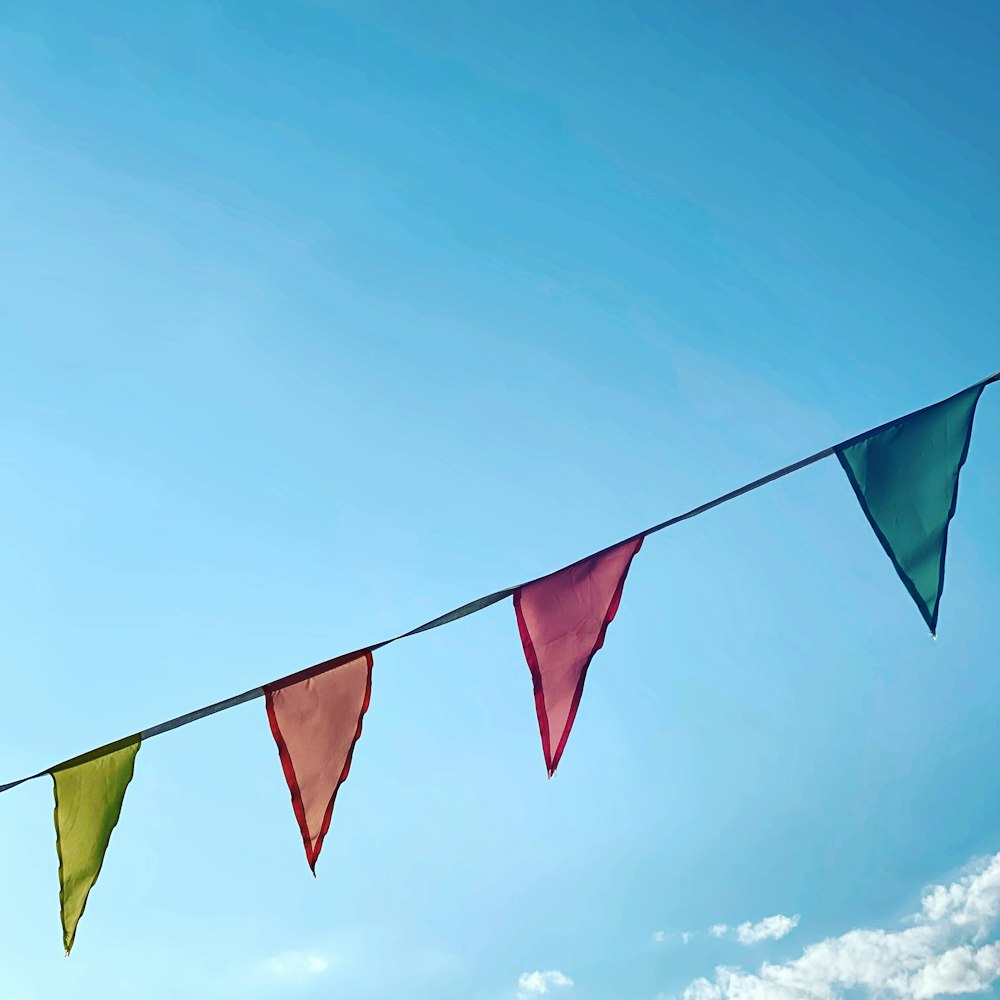 a group of colorful flags hanging from a line