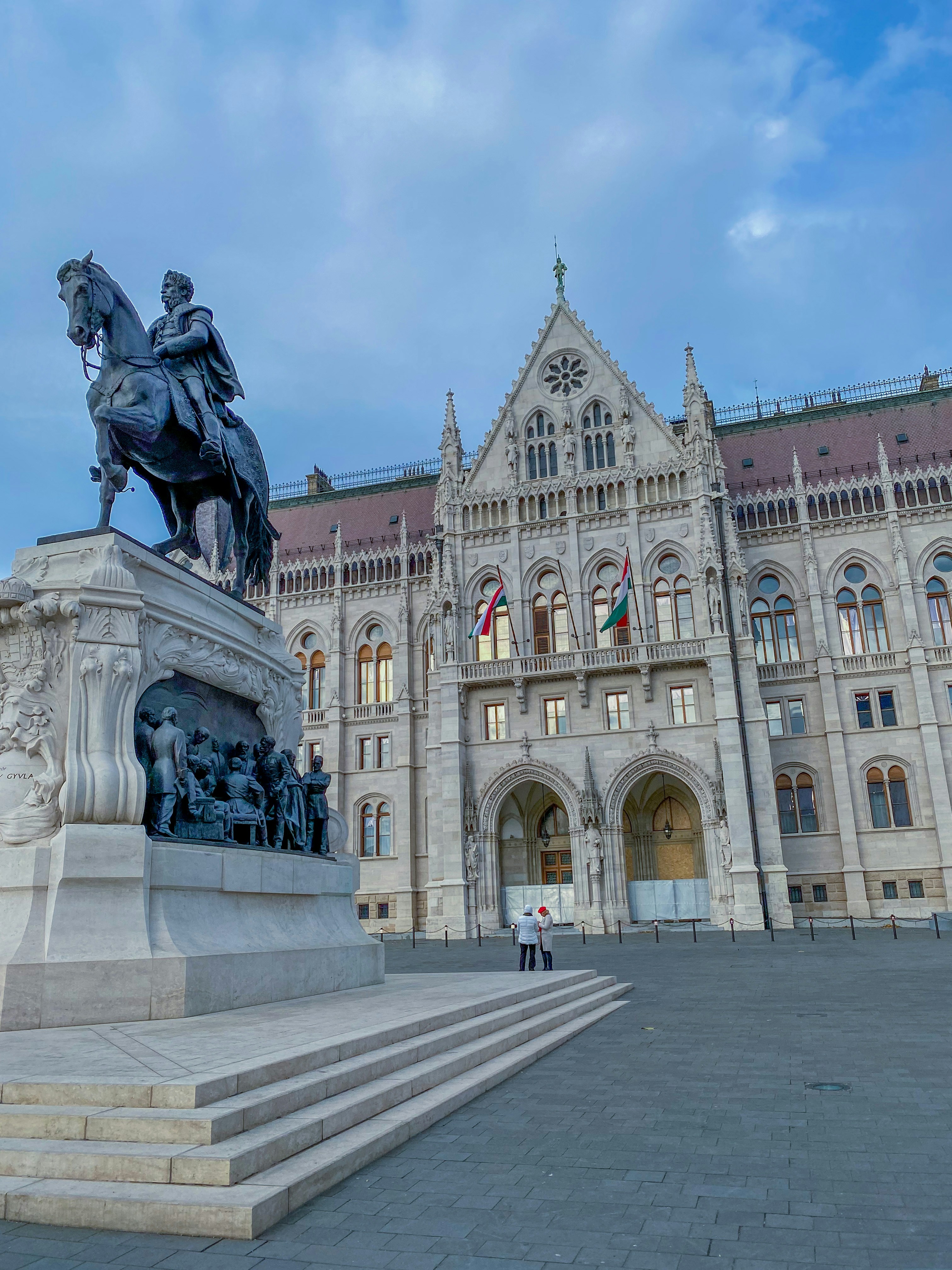 a statue of a man on a horse in front of a building