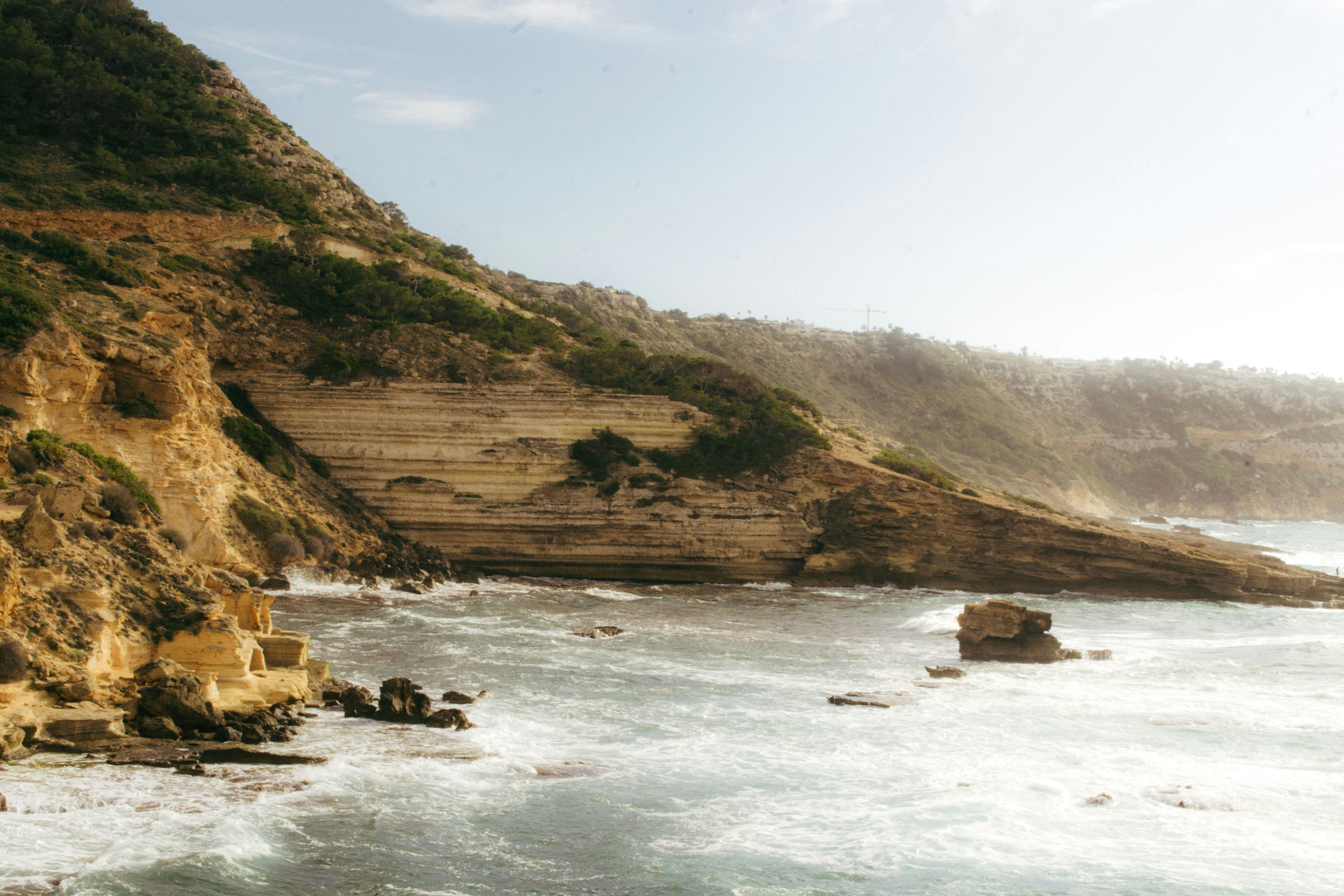 a rocky cliff overlooks a body of water