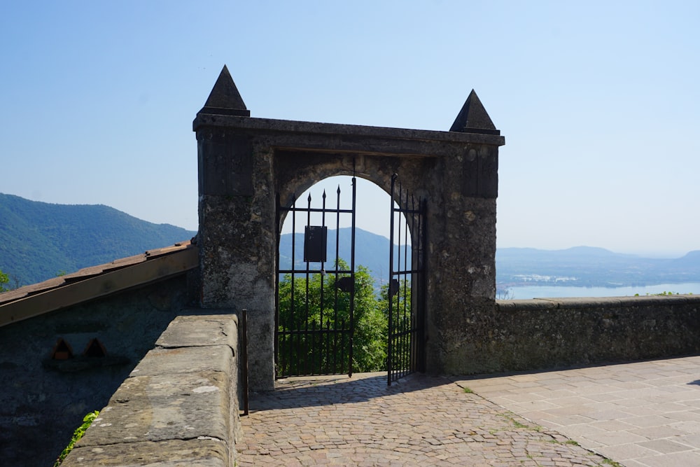 a gate with a bell on top of it