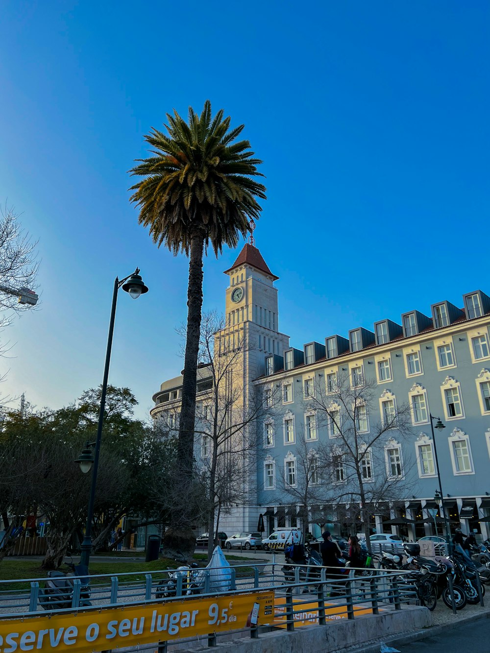 a large building with a palm tree in front of it