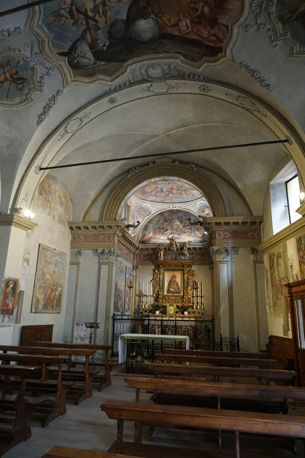 the interior of a church with wooden pews