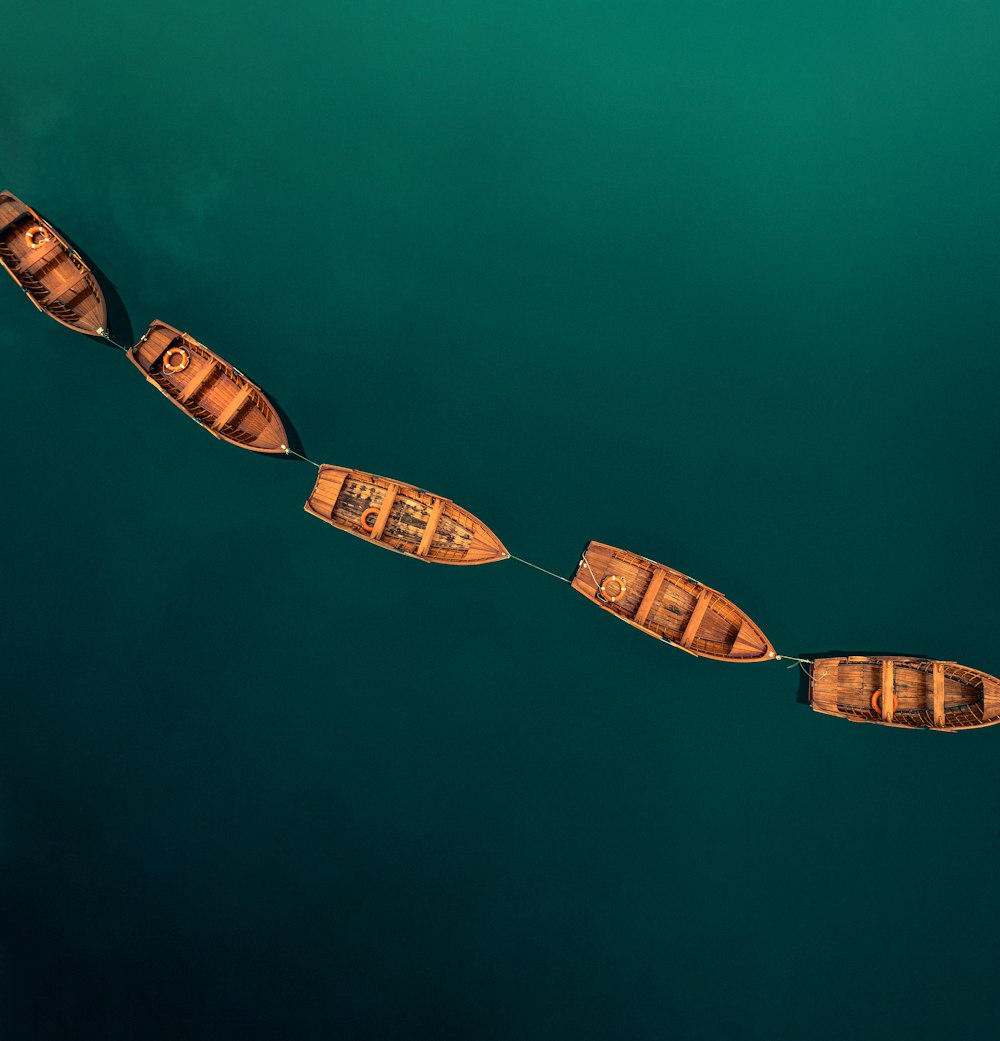 a couple of boats floating on top of a body of water