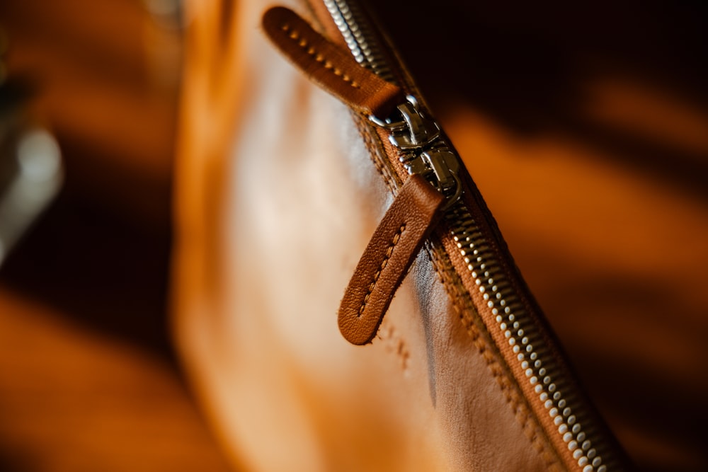 a close up of a brown leather purse