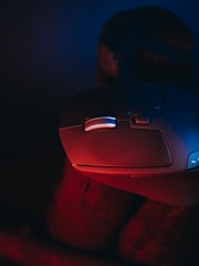 Close-up of hands fixing a computer mouse.