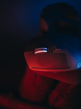 Close-up of hands fixing a computer mouse.