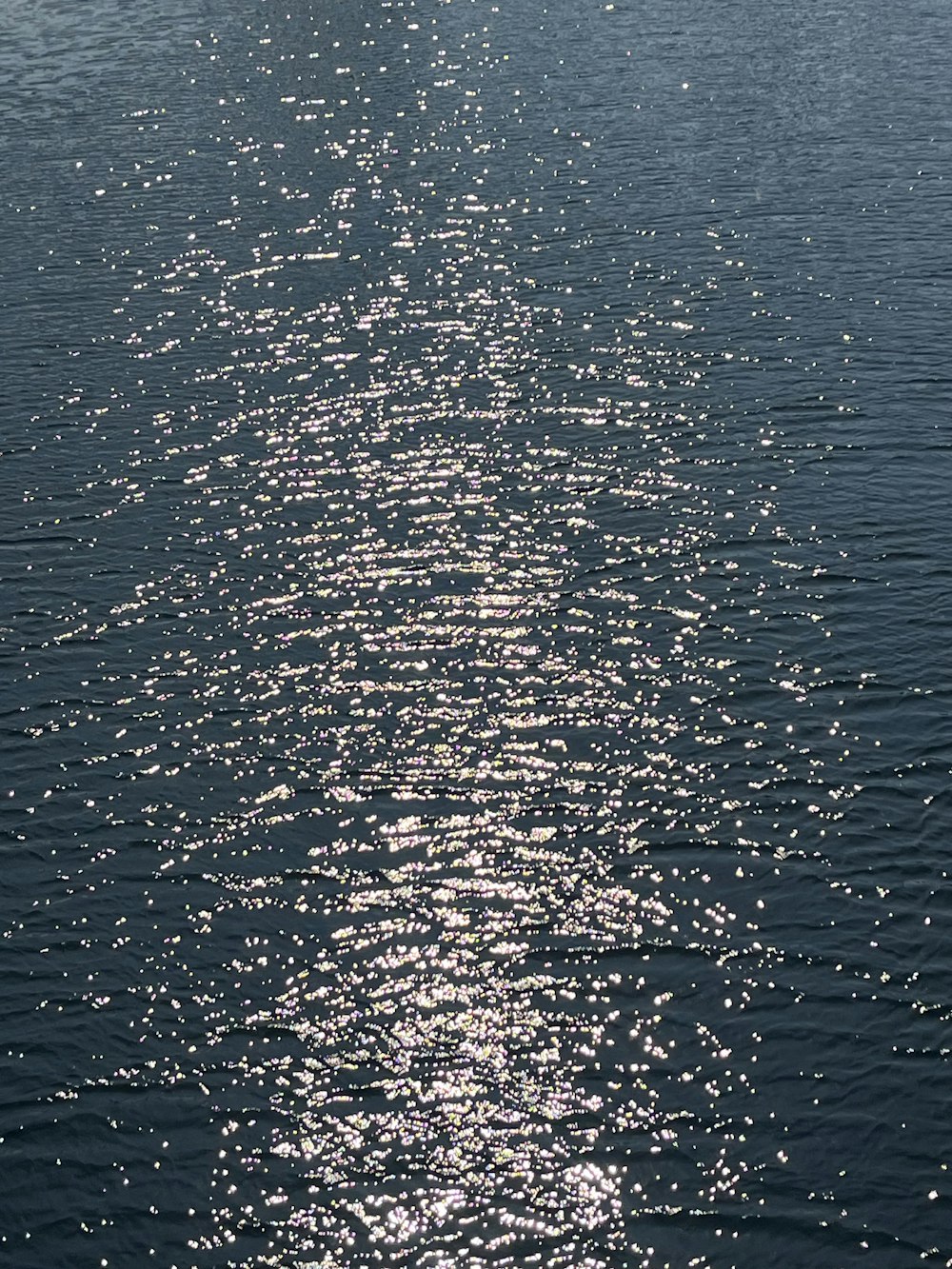 a long line of water with a boat in the distance