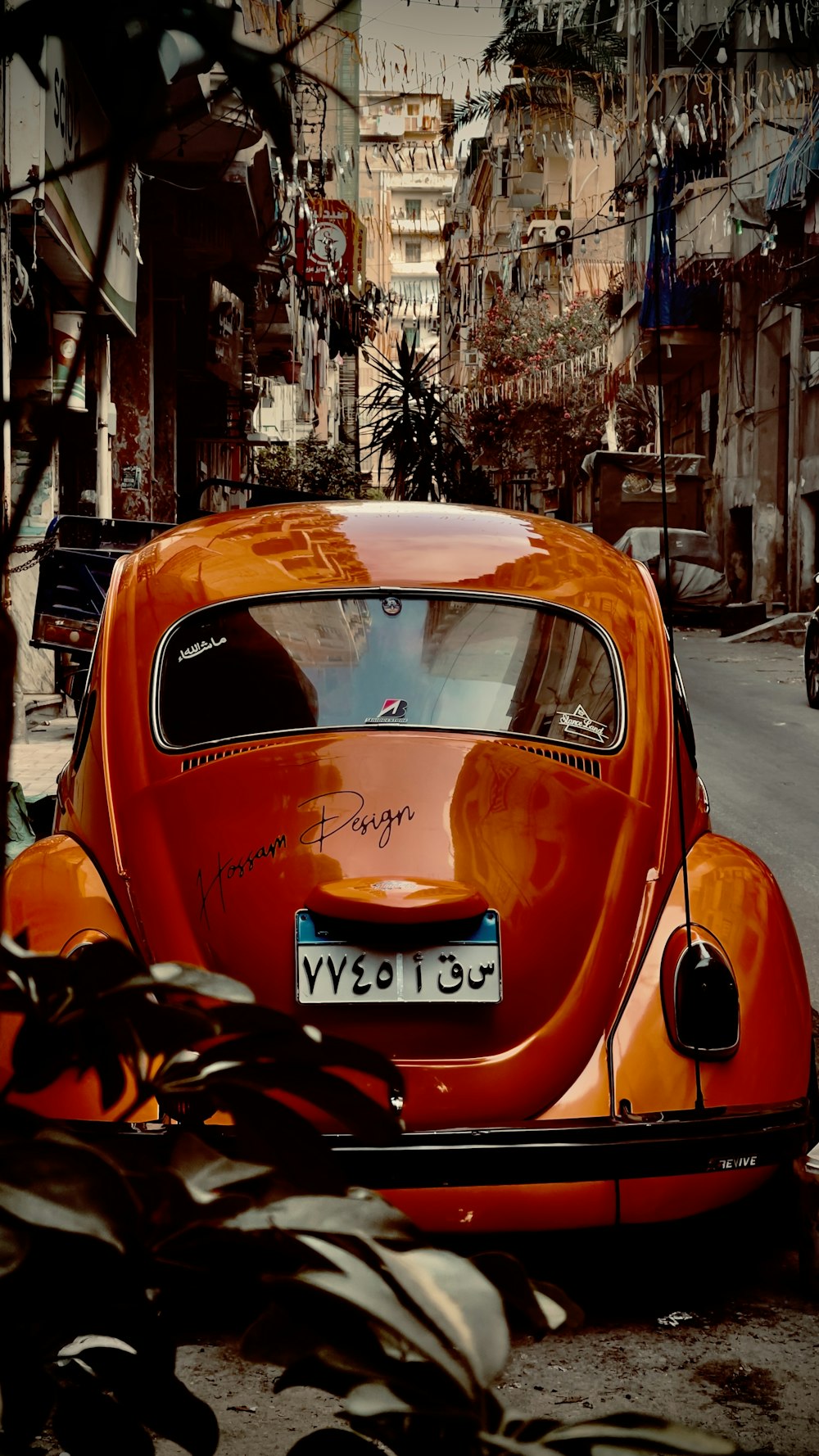 an orange car parked on the side of the road