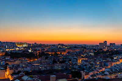 a view of a city at sunset from a hill