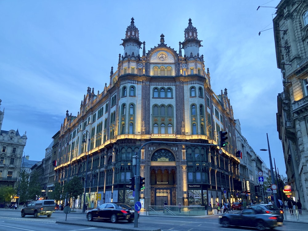 a large building on a city street at dusk