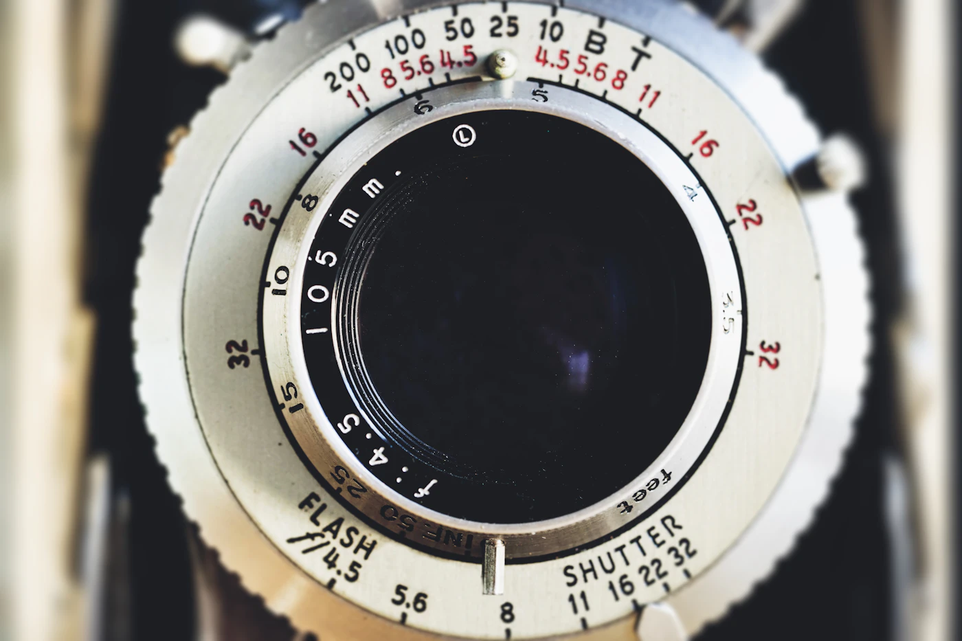 Aperture and focus markings on a vintage lens