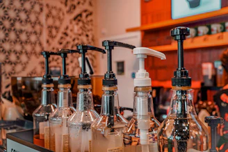 a row of soap dispensers sitting on top of a counter