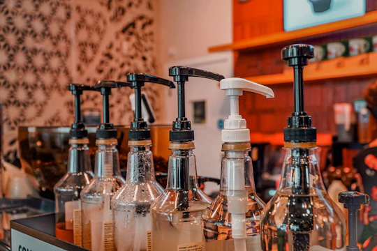 a row of soap dispensers sitting on top of a counter