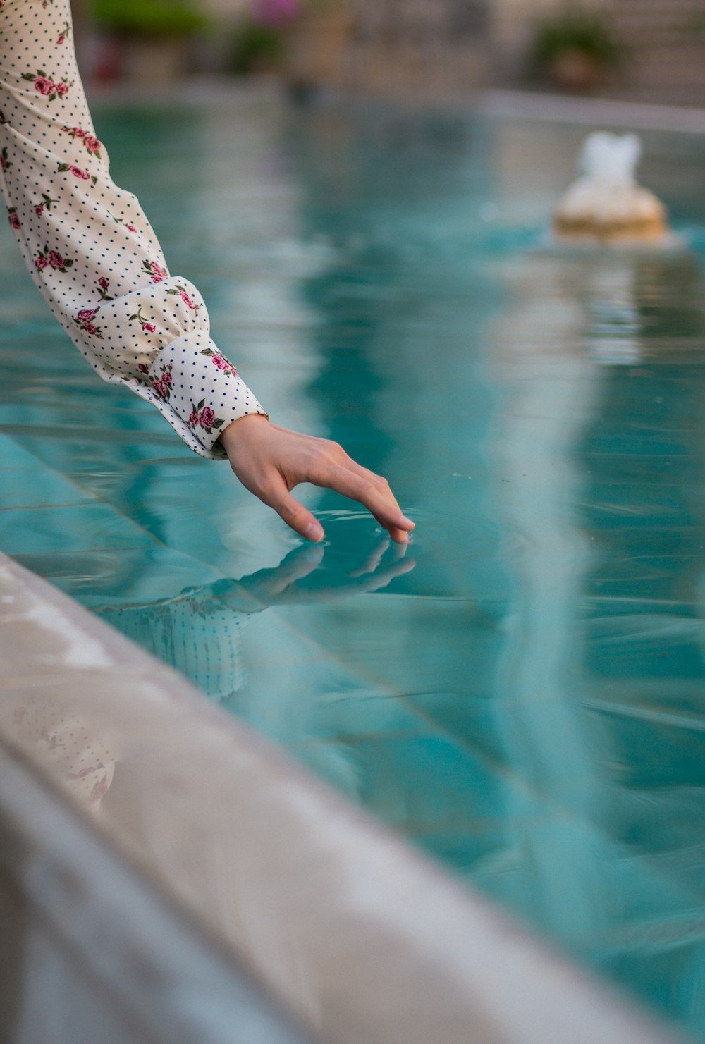 a person reaching for something in the water