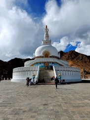 a large white building with a white and blue roof