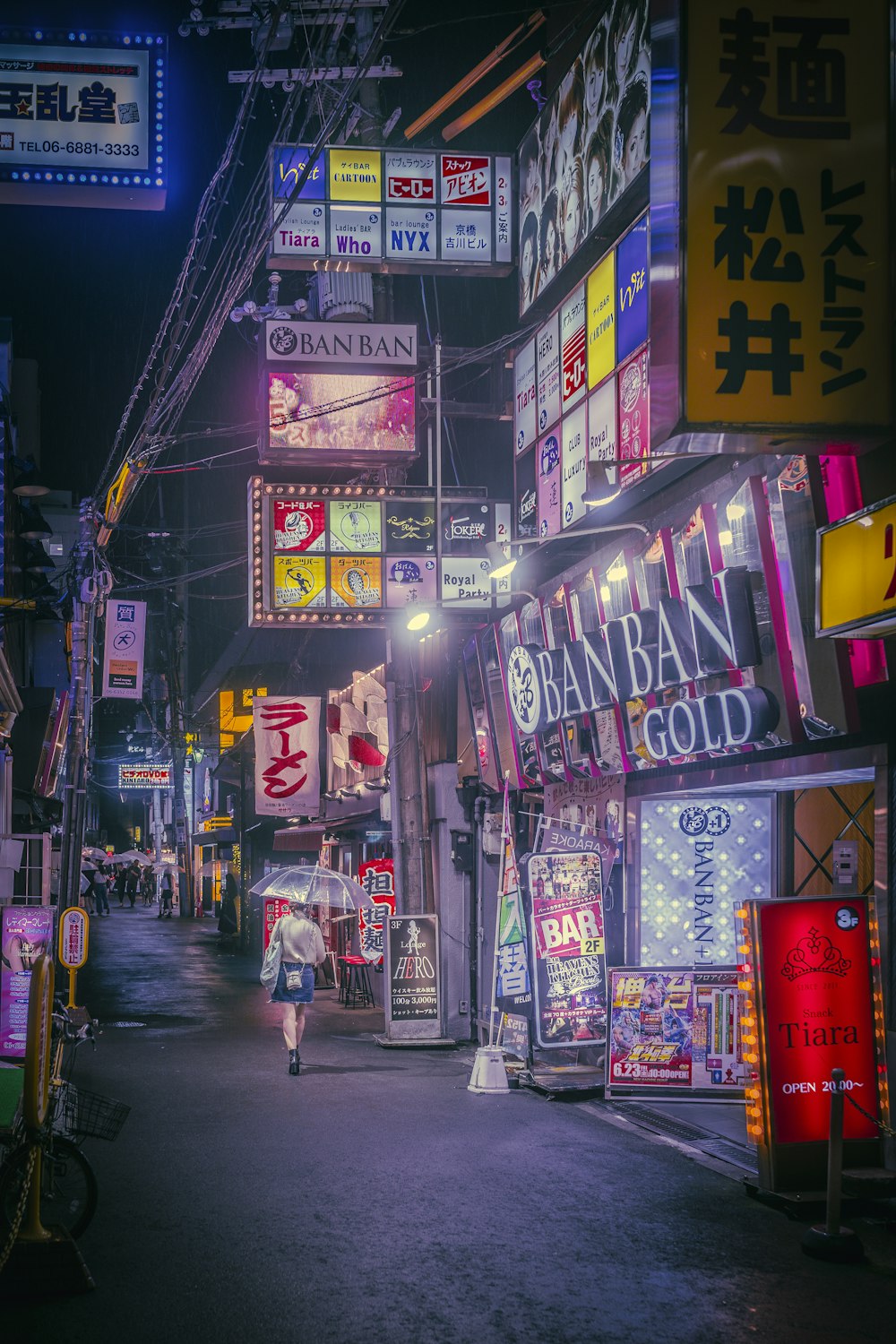 a person walking down a street at night