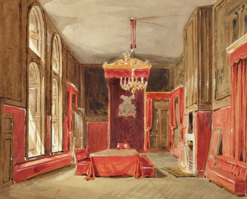 The image depicts a grand, opulent room with high ceilings and large arched windows that allow natural light to flood the space. The walls are painted a rich red color, creating a warm and inviting atmosphere. A chandelier hangs from the ceiling, casting a soft glow throughout the room. In the center of the room is a large bed draped in a vibrant red blanket with gold trim, adding an element of luxury and comfort to the space. To the right of the bed, there are two couches facing each other, providing ample seating for guests. The floor is covered in a plush carpet that complements the overall luxurious feel of the room.