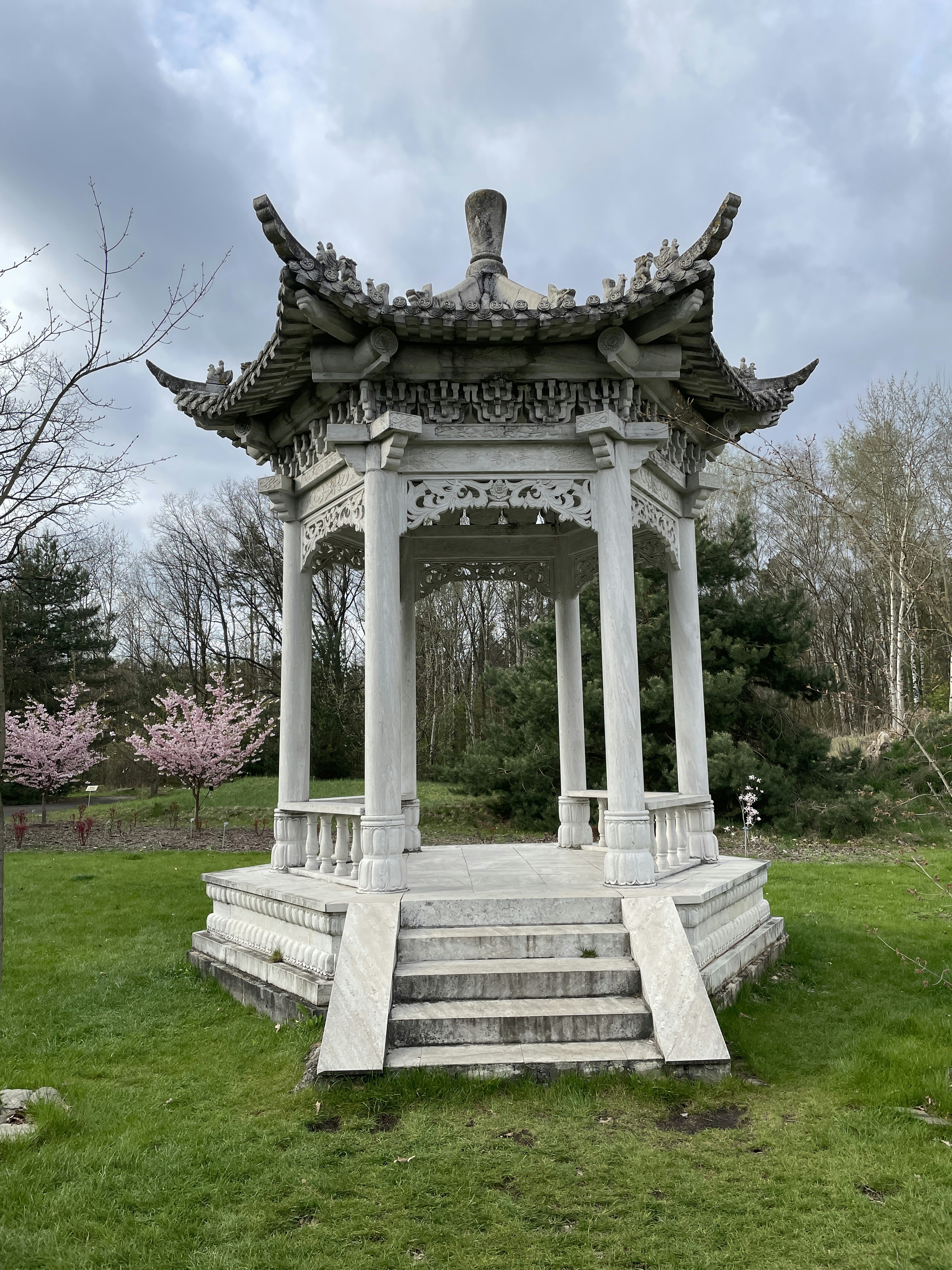 a gazebo in a park with steps leading up to it