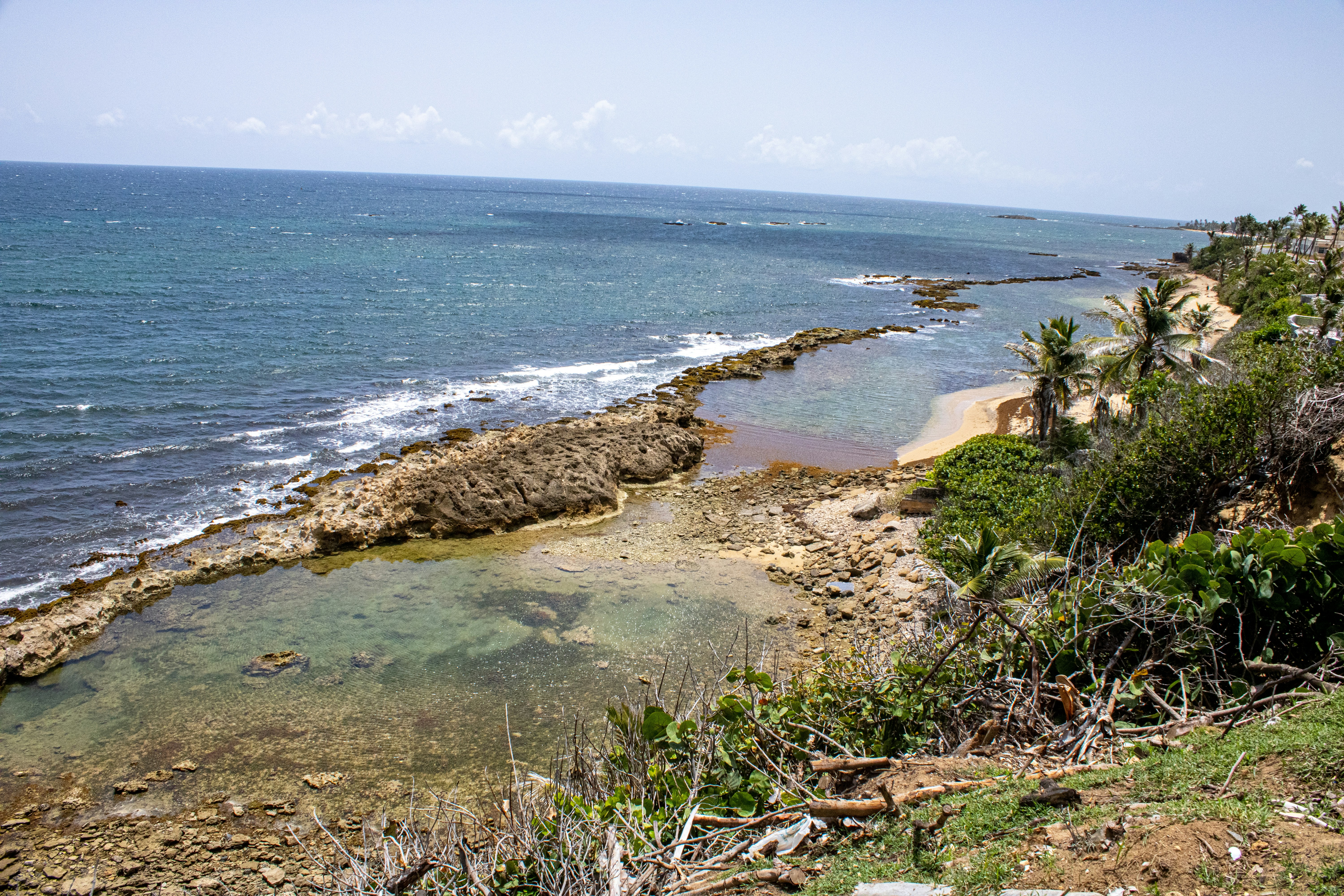 a view of the ocean from the top of a hill