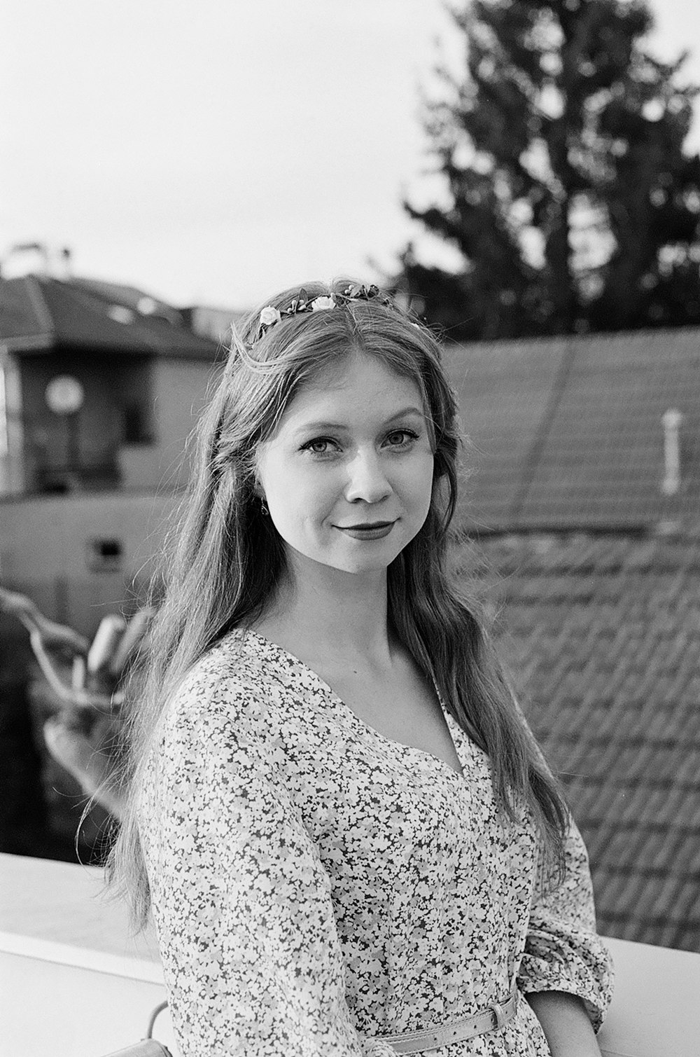 a young woman is posing for a black and white photo