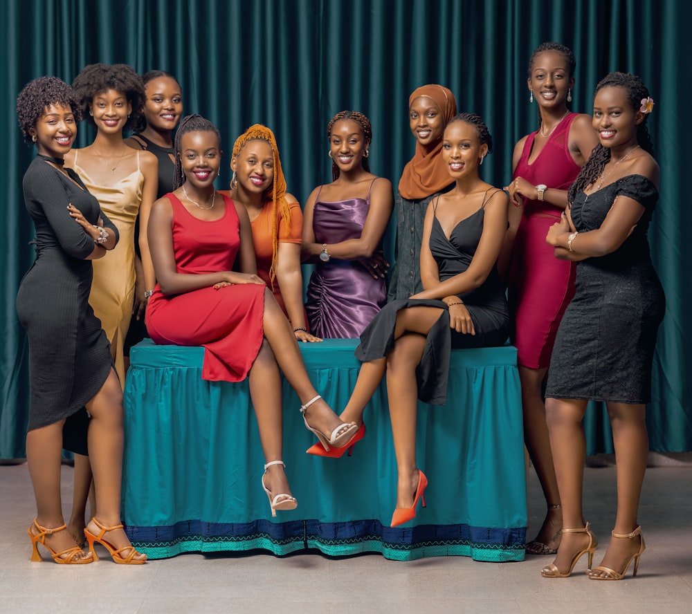 a group of women sitting on top of a table