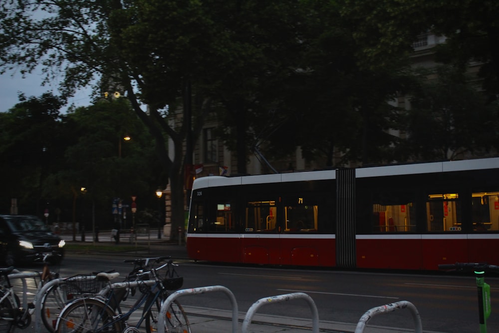 a red and white train traveling down a street