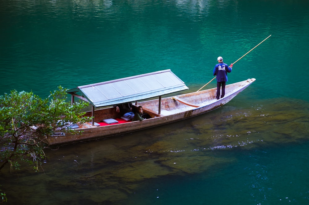 a man standing on a boat in the water