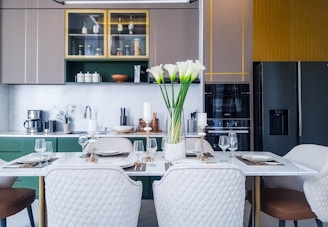 Modern kitchen area with all necessary appliances and a dining table.