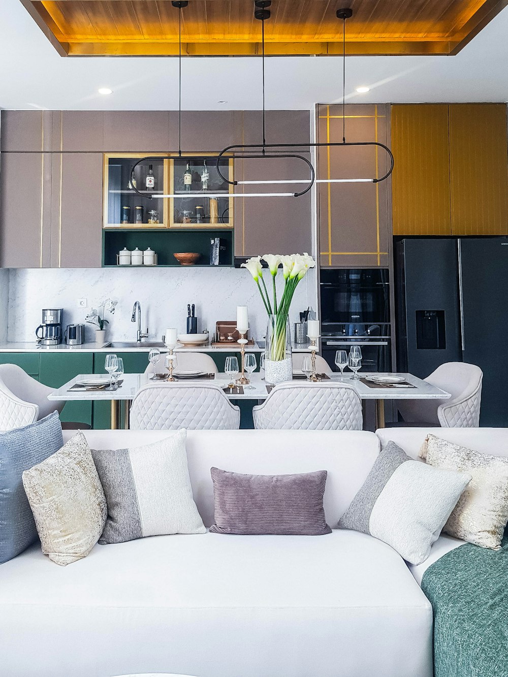 a living room filled with furniture and a kitchen