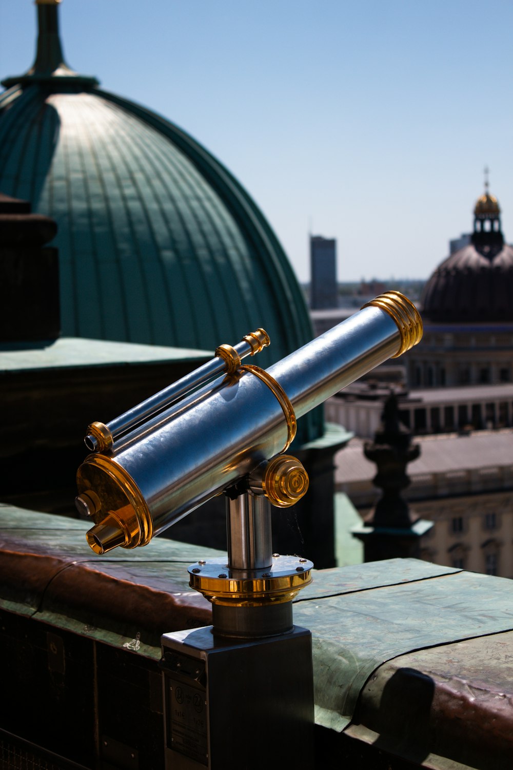 a telescope sitting on top of a metal pole