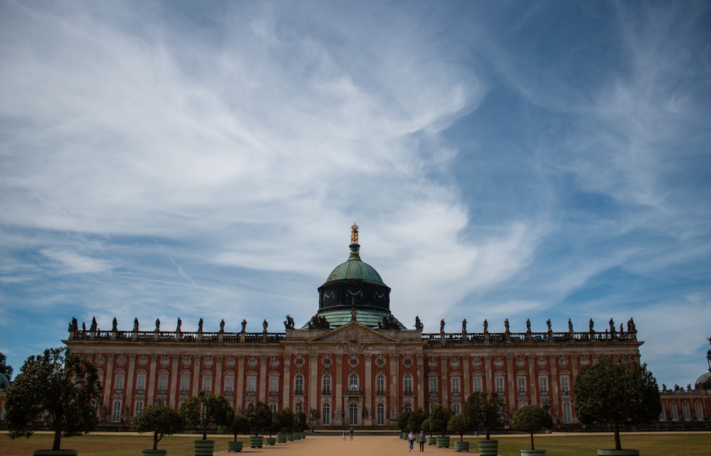 a large building with a green dome on top of it