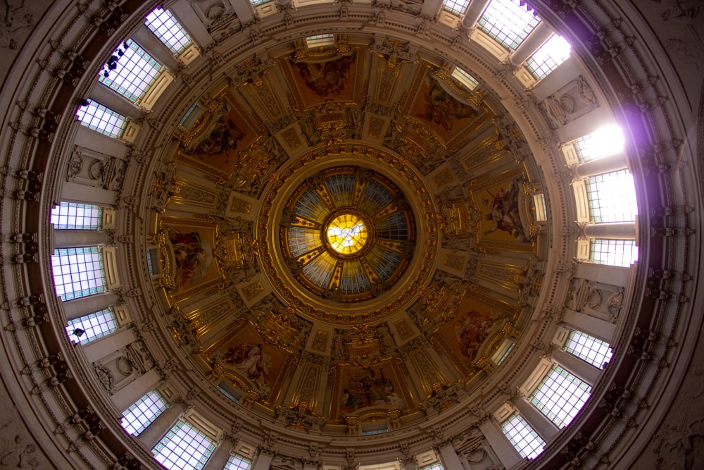 the ceiling of a large building with many windows