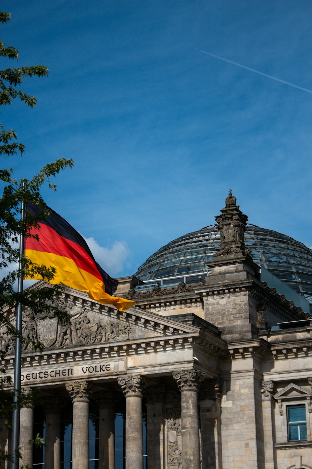 a german flag flying in front of a building