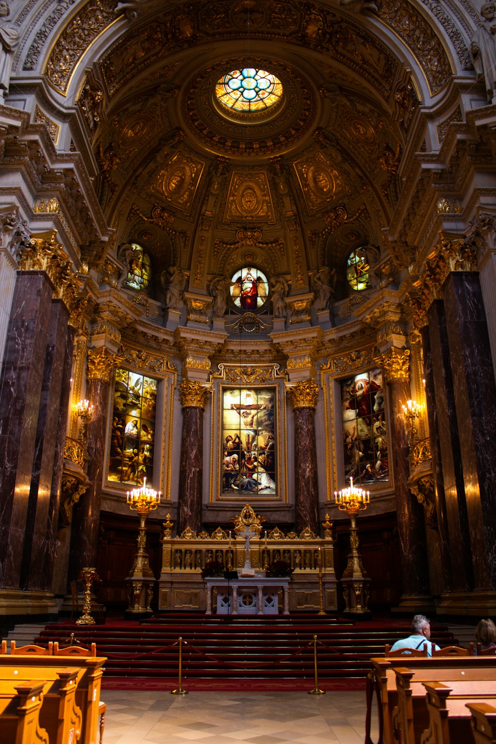 a church with a large alter and stained glass windows