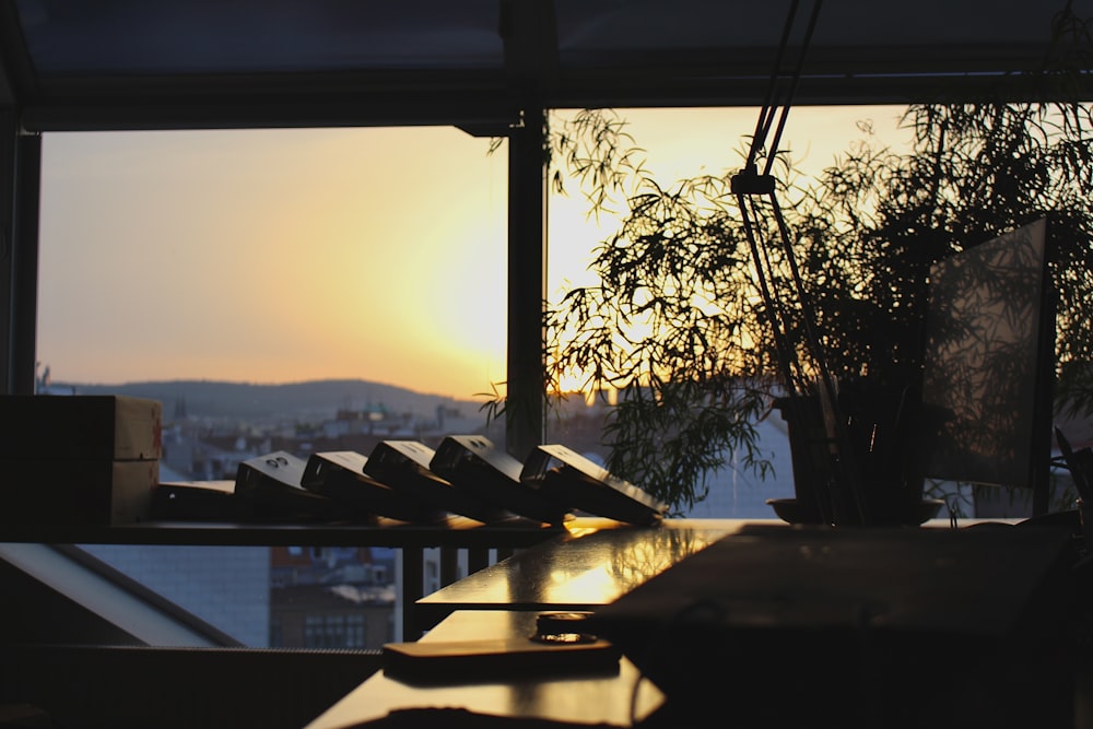 the sun is setting over a city from a restaurant