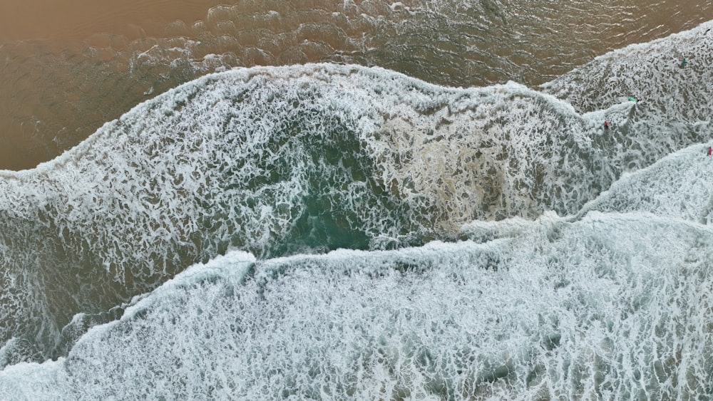 a person riding a surfboard on a wave in the ocean