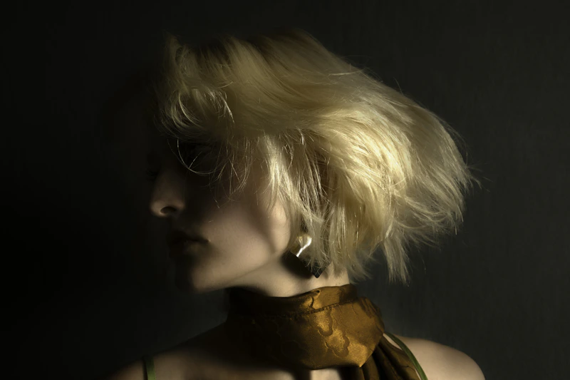 Charming sugar baby with blonde hair and a stylish scarf