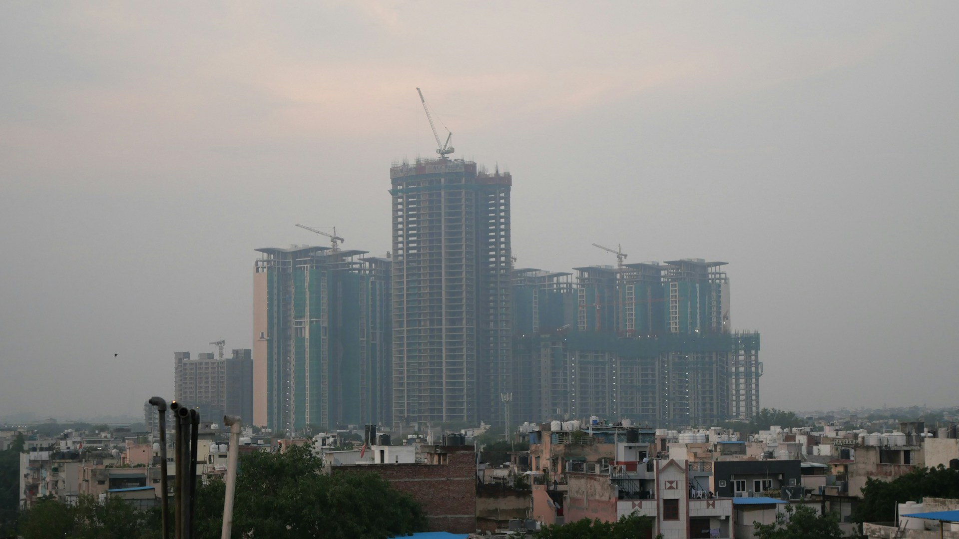 a view of a city with tall buildings under construction